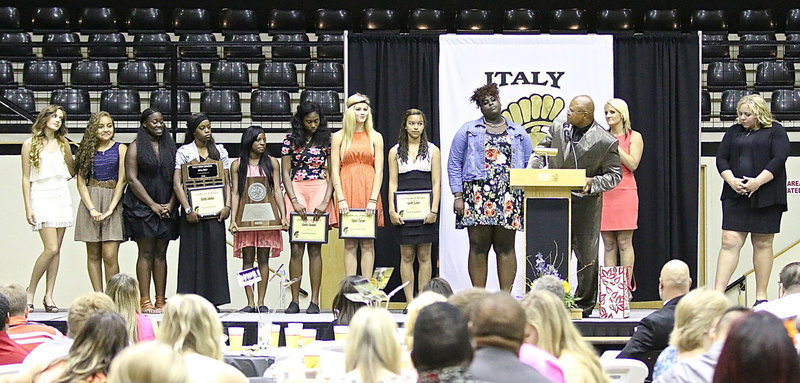 Image: Lady Gladiator Track and Field members are (L-R): Jozie Perkins, Vanessa Cantu, Taleyia Wilson, Kortnei Johnson (Team MVP), Kendra Copeland, Janae Robertson (Most Improved Girl), Halee Turner, April Lusk and Shercorya Chance. Coach Bobby Campbell brags on the team and their success at the State level as coaches Morgan Mathews and Melissa Fullmer look on.