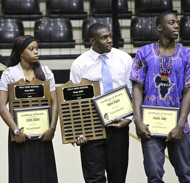 Image: Girls Track MVP Kortnei Johnson, Boys Track MVP TaMarcus Sheppard and Khumbo Bailey who received a Fighting Heart Award in track await the next award winner to be announced.