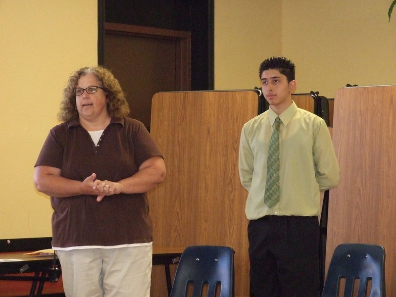 Image: Mrs. Marilyn Seidlitz (pictured here with, honor art student, Joseph Sage) at a recent school board meeting