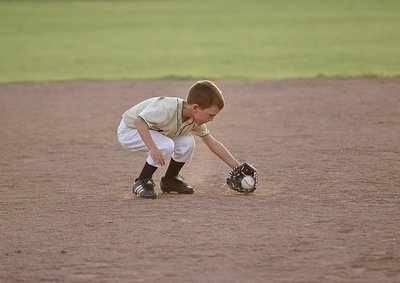Image: Bryson Sigler(4) secures a ground ball for the IYAA T-Ball Gladiators.