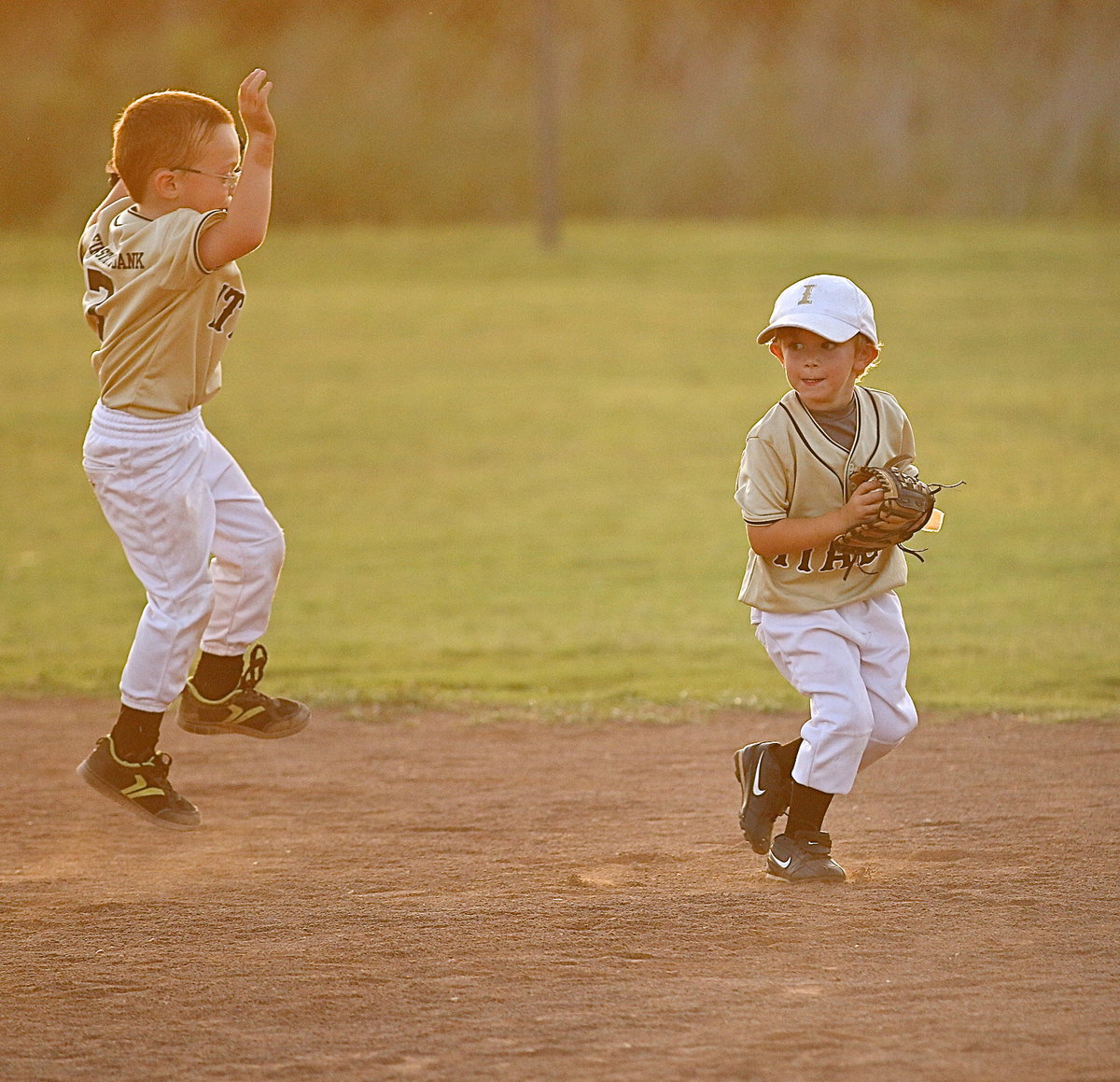 Image: Outfielder Riley Roldan(14) hustles to back up the infield by scooping up a grounder as teammate Ayden Thompson(7) cheers for his buddy, Roldan!