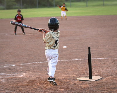 Image: Trent Connor(9) hits the ball off the tee and then runs to first-base for the IYAA T-Ball Gladiators.