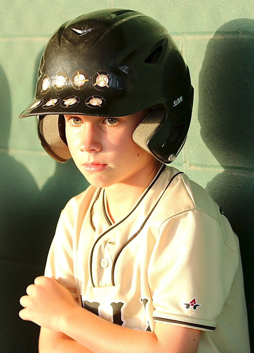 Image: Levi Joffre(5) battles thru an injury as he prepares to hit off the tee for the IYAA T-Ball Gladiators.