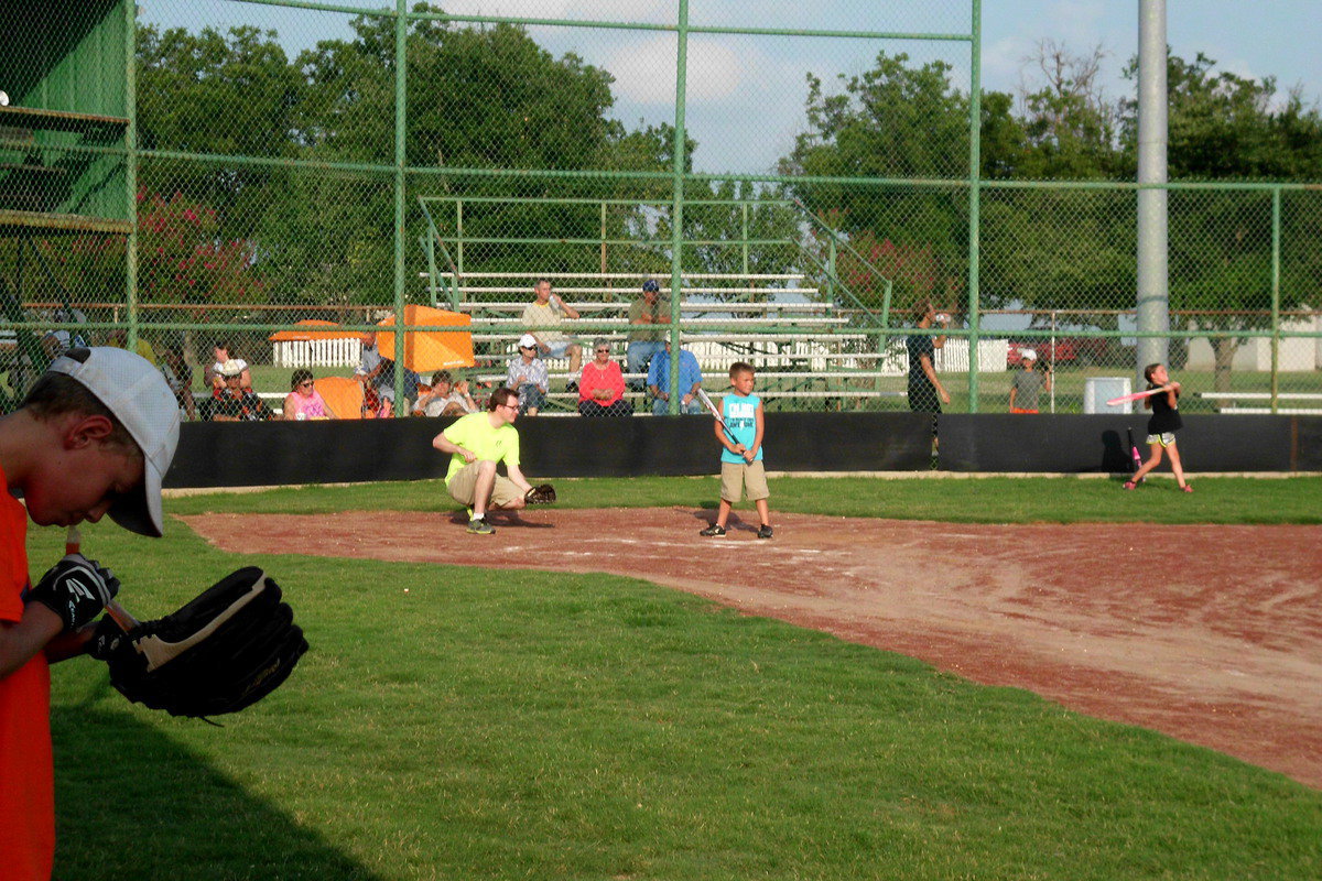 Image: Gavin Ramirez is ready for the pitch. Pastor Joseph Barrett proves he can catch as well as preach.