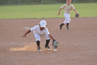 Image: Cason Green(10) attacks a grounder hit to the mound.