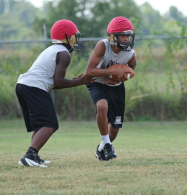 Image: Freshmen Kendrick Norwood and Tylan Wallace runs some offensive sets with Maypearl red for bonnets to entice Italy’s varsity Panther slayers.