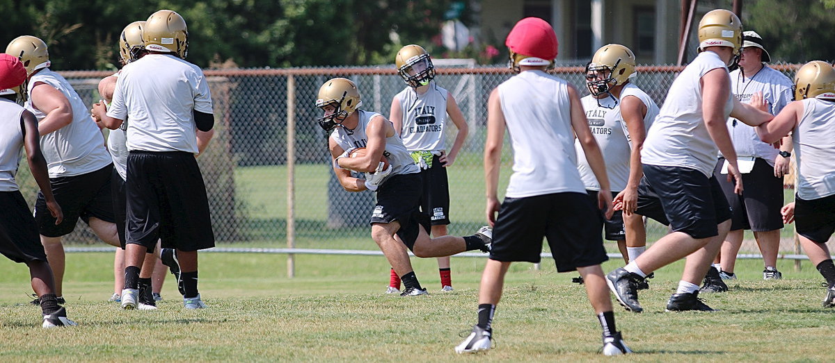 Image: Hunter Merimon takes the handoff with the offense working things out.