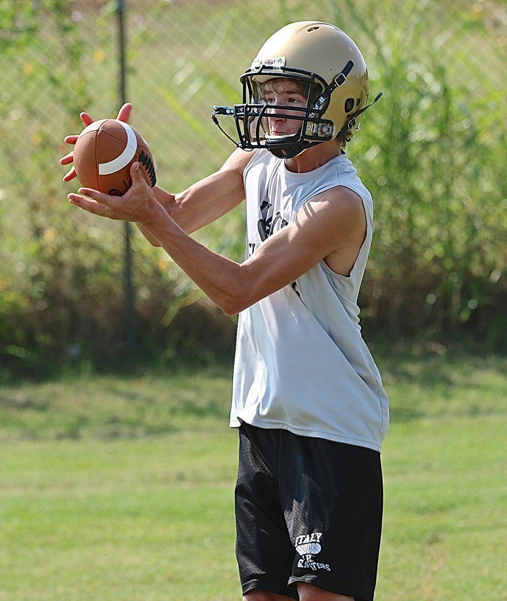 Image: Freshman, Garrett Janek pulls in a pass during a route running drill.