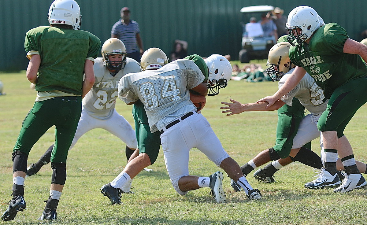 Image: JV Gladiator Chris Davila(84) slams the door shut on an Eagle running back.