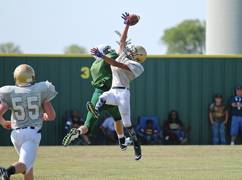 Image: JV Gladiator Tylan Wallace(9) breaks up a long pass attempt by the Eagles.