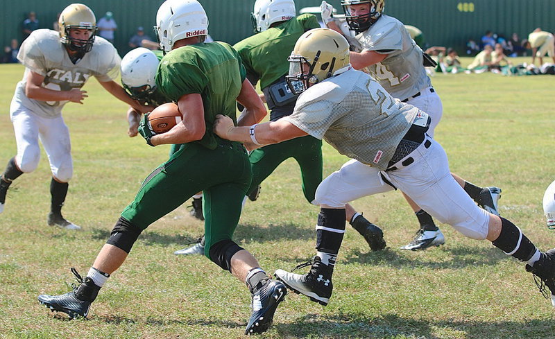 Image: Gladiator defensive tackle John Escamilla(21) goes after a ball carrier in the Eagle backfield.
