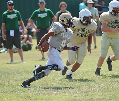 Image: JV Gladiator quarterback Tylan Wallace(9) takes matters into his own hands as he breaks a big run for Italy.