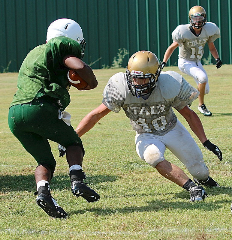 Image: Italy Gladiator linebacker Coby Jeffords fills the gap to bring down a Valley Mills Eagle running back during a scrimmage between the two towns.
