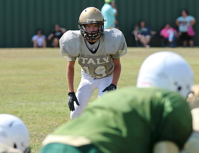 Image: JV Gladiator Garrett Janek(19) eyes the Valley Mills’ quarterback before the snap of the ball.