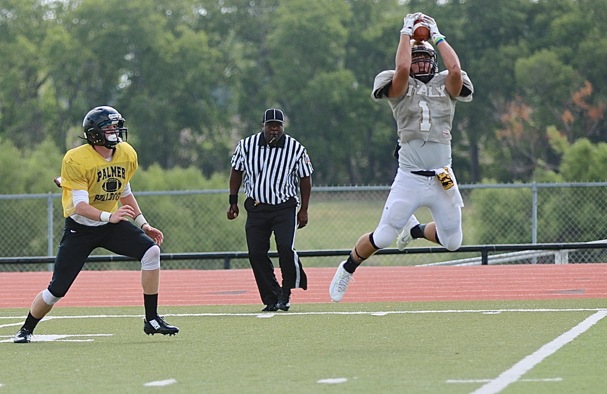 Image: Italy’s outside linebacker Hunter Merimon(1) intercepts a Palmer pass and then runs for a few yards before Palmer’s Brian Archibald pulls him down.