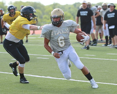 Image: Palmer’s Brian Archibald tries to keep Italy’s Joe Celis(6) from getting the edge during a quarterback keeper.
