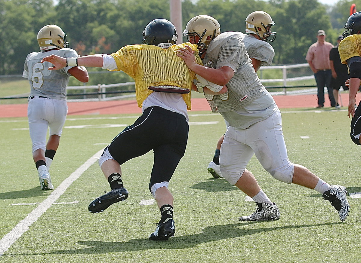 Image: Right tackle John Byers(99) drives Palmer’s end, Brian Archibald, away from his quarterback, teammate Joe Celis(6), until the whistles blows.