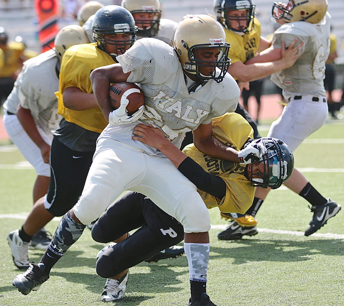 Image: Jaray Anderson(24) tries to fight off a Bulldog who is nipping at his heels during a sweep play.