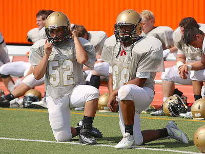 Image: JV Gladiators Edgar Solis(52) and Chris Munoz(68) buckle up as they prepare to enter the fray against Palmer.