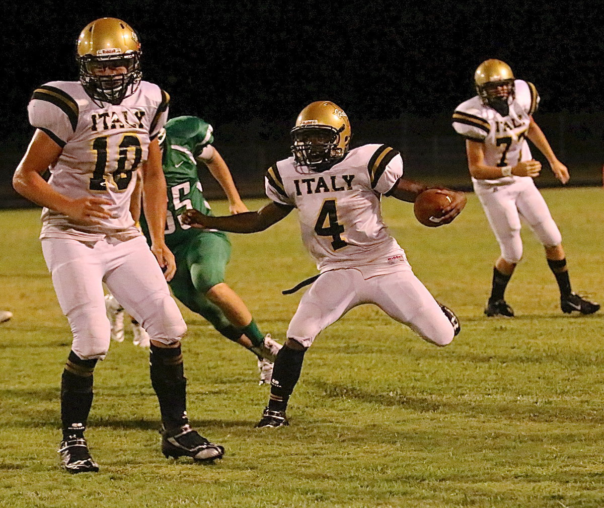 Image: Against Kerens, senior fullback Coby Jeffords(10) clears a path for freshman tailback Kendrick Norwood(4). The Bobcat Jeffords was blocking was sent flying out of frame.