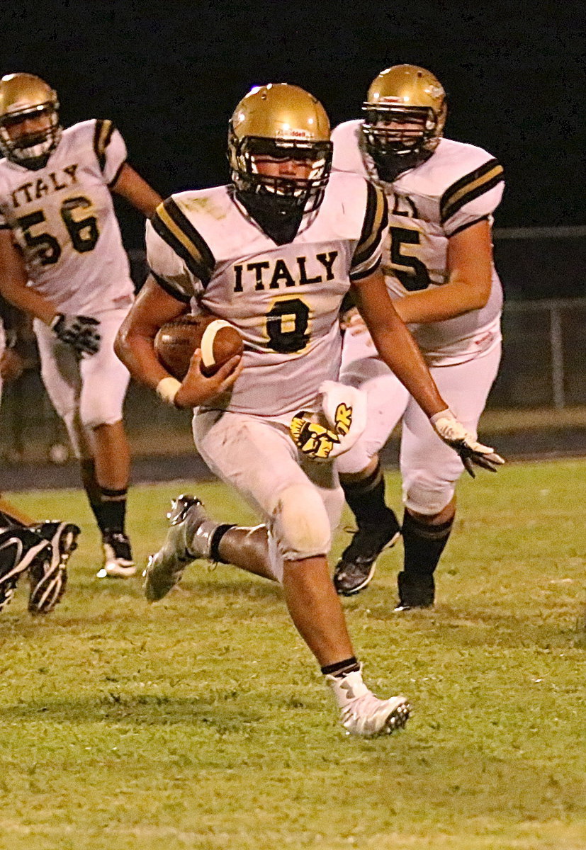 Image: Gladiator quarterback Joe Celis(8) finally finds a running lane in the fourth-quarter against Kerens.