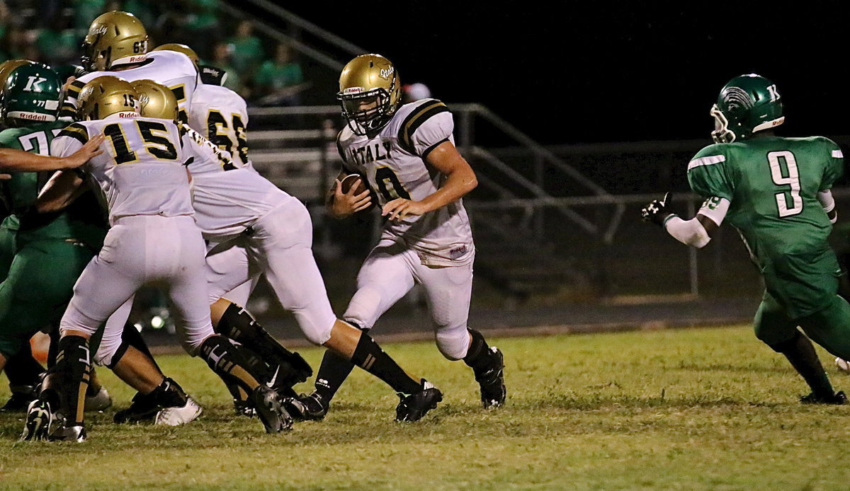 Image: Cody Boyd(15), Clay Riddle(77), Aaron Pittmon(65) and Kyle Fortenberry(66) open a hole for fullback Coby Jeffords(10).