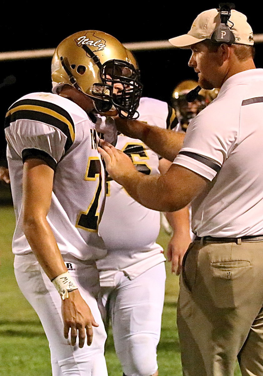 Image: Clay Riddle(77) gets some advice from, line coach, Jon Proud.