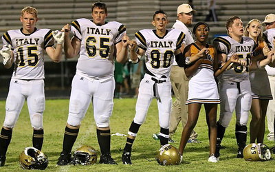 Image: The school song — Cody Boyd(15), Aaron Puttmon(65), jack Hernandez(80), K’Breona Davis, John Escamilla(50) and Kelsey Nelson show their Gladiator pride during the playing of the school song.