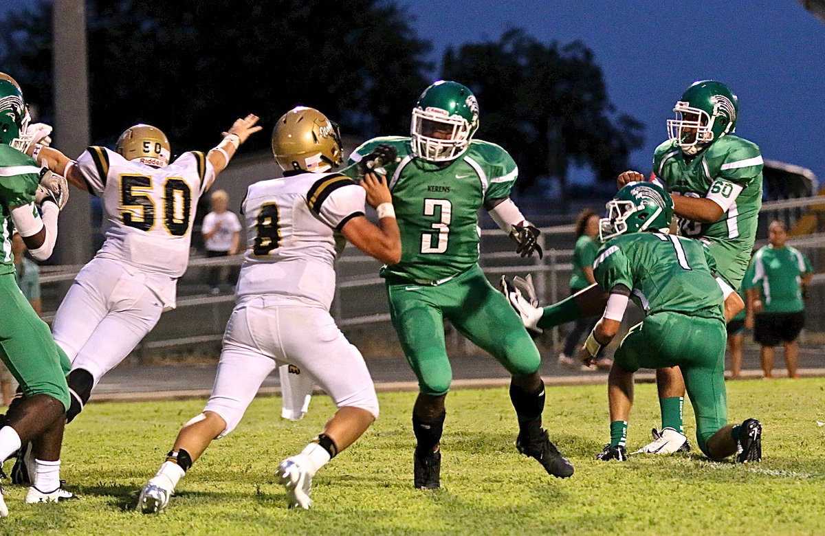 Image: Superhuman John Escamilla(50) flies in to block one of his 3 P.A.T. blocks in the game. One was nullified due to a penalty but the feat was very impressive.