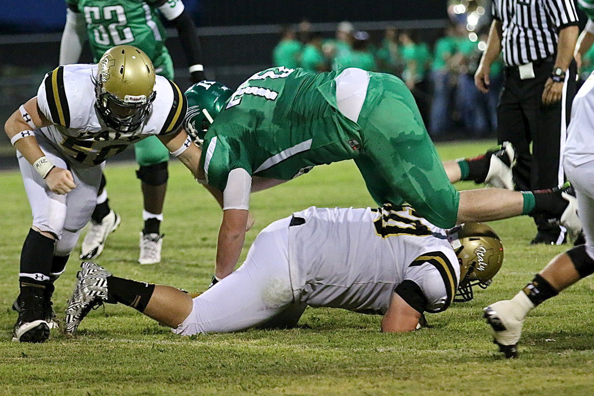 Image: John Escamilla(50) and John Byers(60) take care of a Bobcat defenseman.