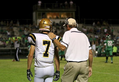 Image: Gladiator head football coach Charles Tindol sends a play in with Ryan Connor(7).