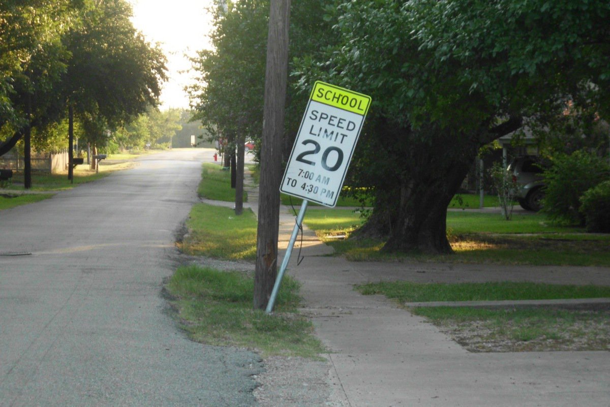 Image: This sign on Park Street has been leaning for several months. Children must go around it to pass on their way to school. Not sure what the wire is that is tied around it.