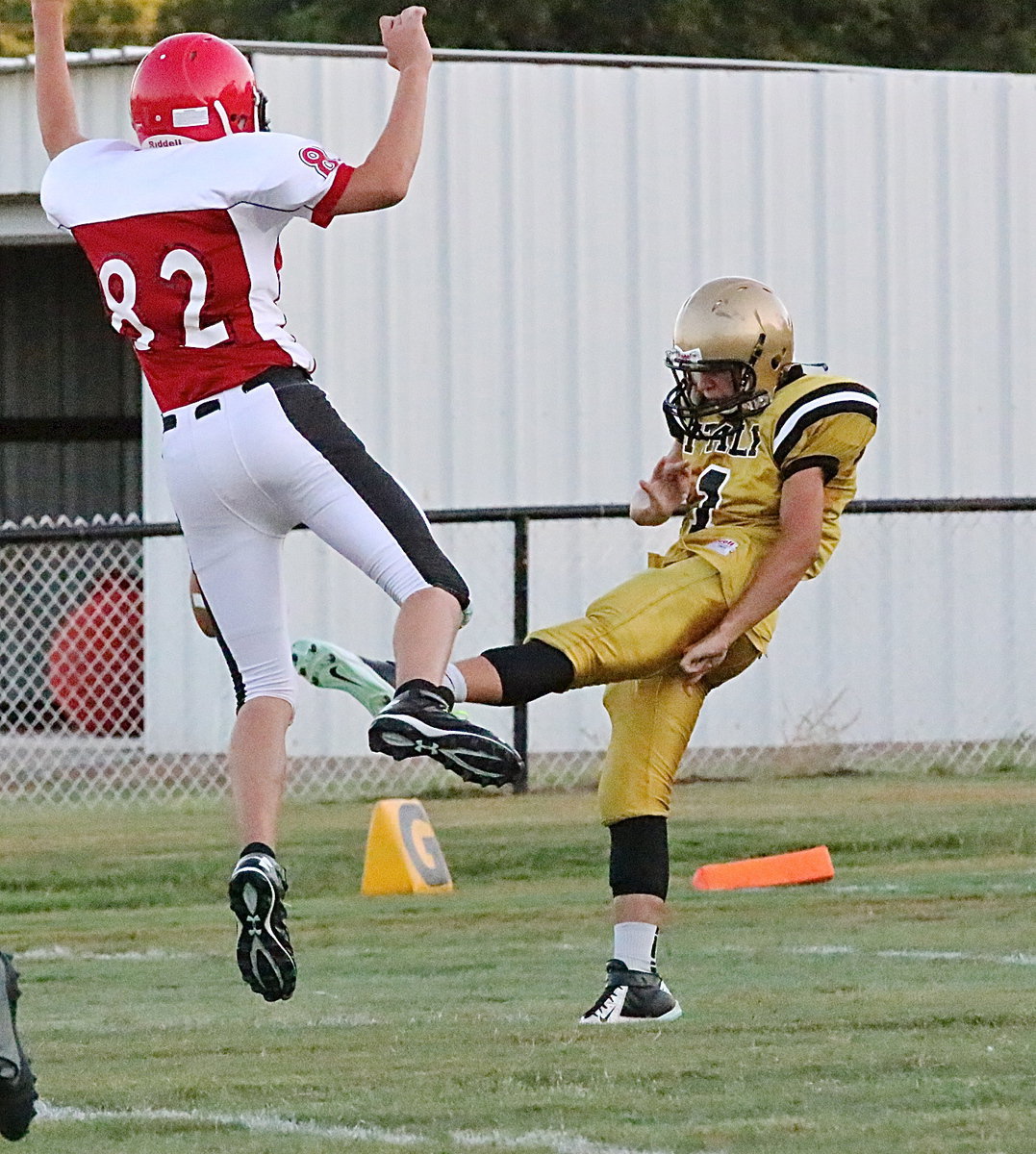 Image: Italy JV Gladiator punter Gary Escamilla(1) hung tough while a Maypearl Panther defender hung in the air hoping for the block. Escamilla’s punt covered the length of the field to pen the Panthers deep.