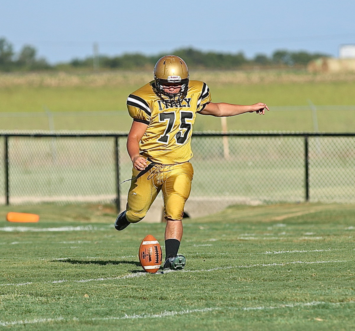 Image: Gary Grant(75) kicks off to start the duel between Italy and Maypearl’s JV squads.