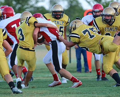 Image: JV Gladiator Dylan McCasland(3) and Barry Grant(75) team up to bring down a Panther ball carrier.