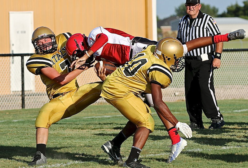 Image: Italy’s Eli Garcia(7) and Jaray Anderson(10) upend a Panther at the goal line.