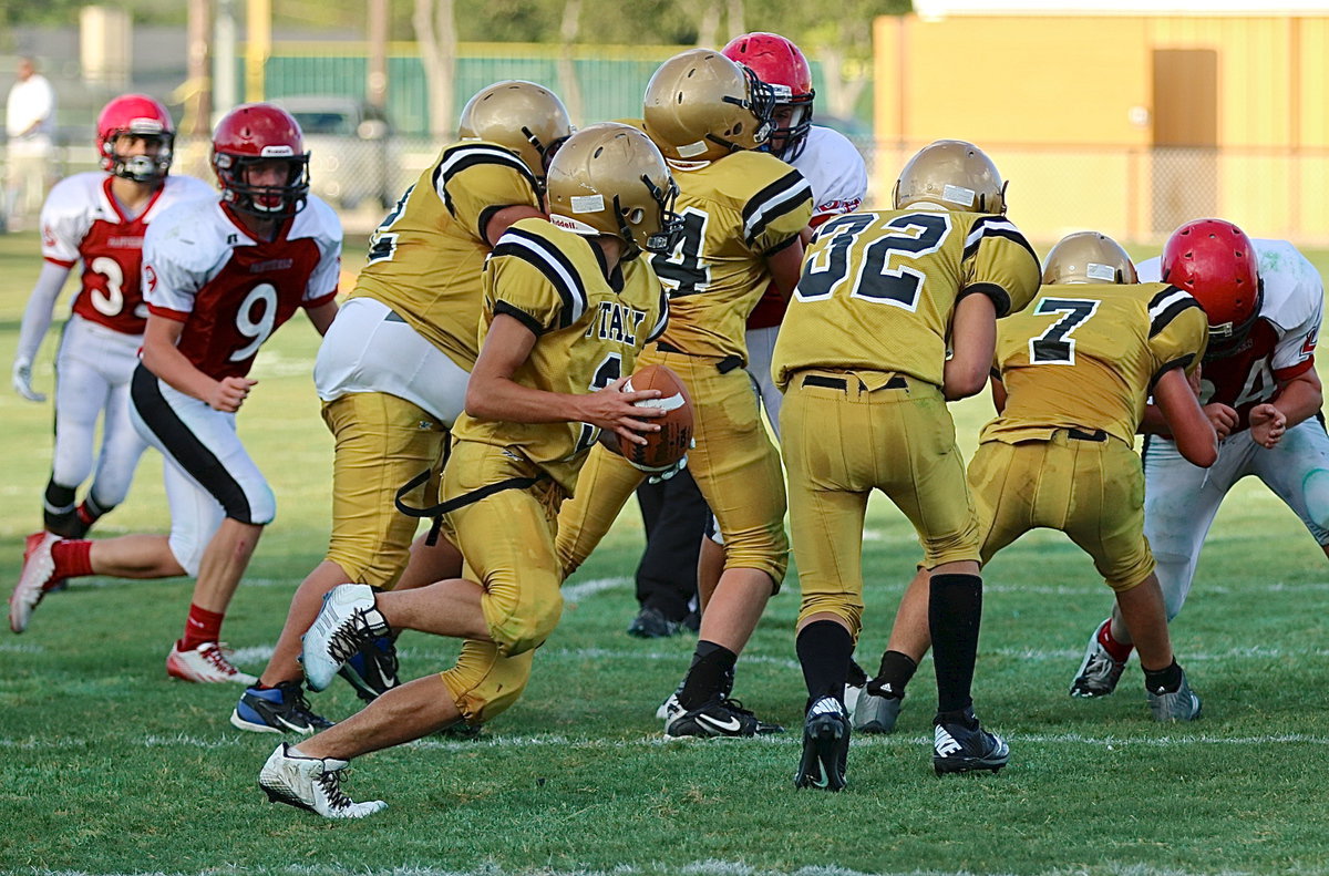 Image: Quarterback Dylan McCasland(3) fakes a handoff to Blake Brewer(32) before connecting on a bomb downfield to teammate Micah Escamilla.