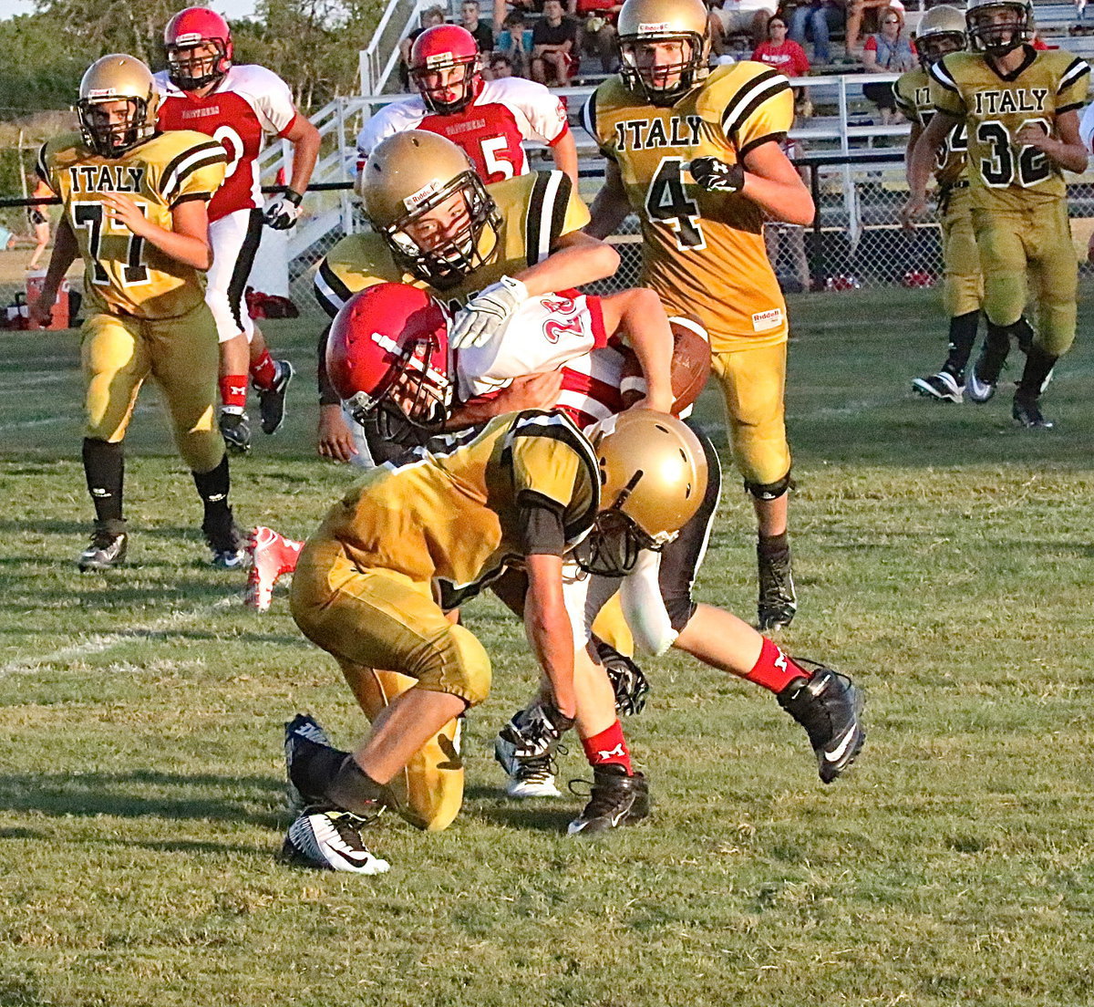 Image: Italy’s Eli Garcia(7) latches on to a Panther ball carrier as teammate Garrett Janek(12) comes up to lower the boom.