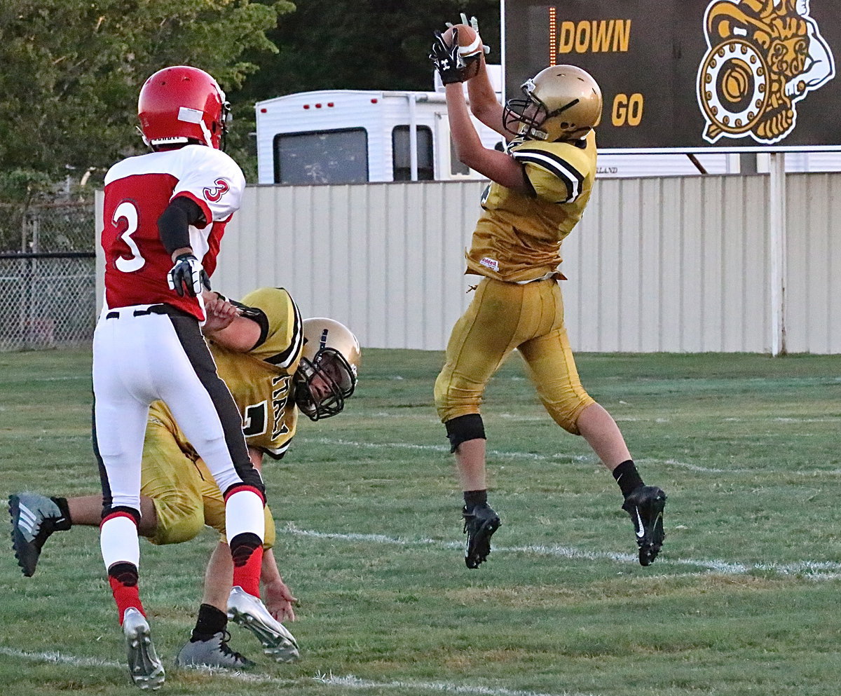 Image: Micah Escamilla(4) pulls in a pass from teammate Dylan McCasland.