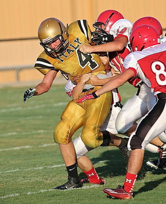 Image: Micah Escamilla(4) tries to tear away from a cluster of Panther tacklers.