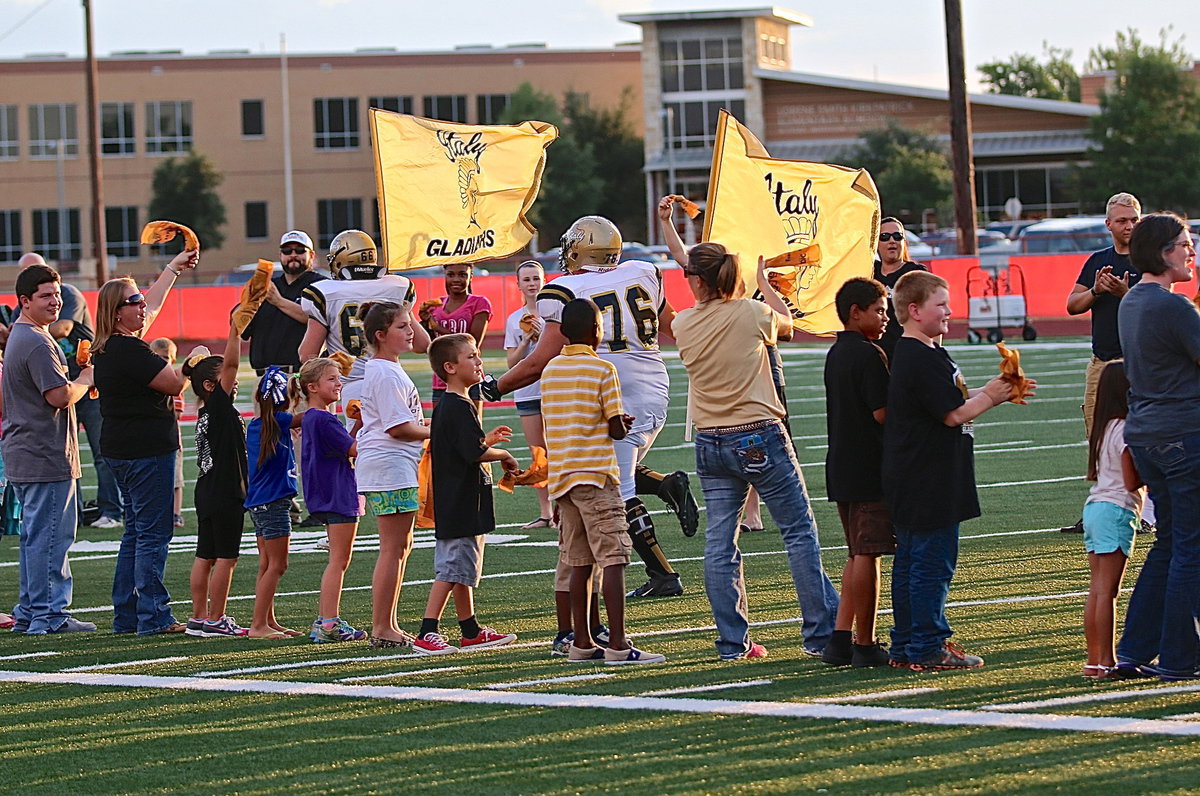 Image: Kyle Fortenberry(66) and Colin Newman(76) lead the Gladiators into battle with Gladiator fans forming spirit lines down the field.