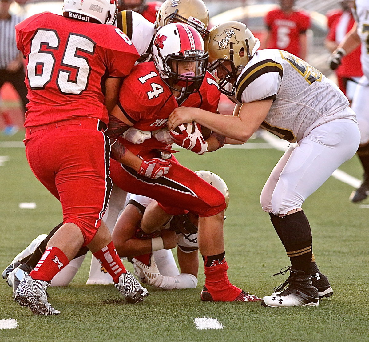 Image: With Joe Celis(8) hanging onto a Panther paw, defensive tackle John Escamilla(50) tries to strip the ball for the Gladiators.