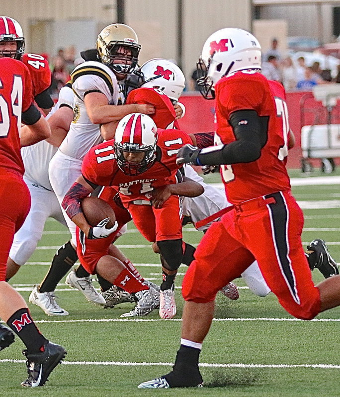 Image: Gladiators Kyle Fortenberry(66) and Kendrick Norwood(4) crash into the Panther backfield for a stop.