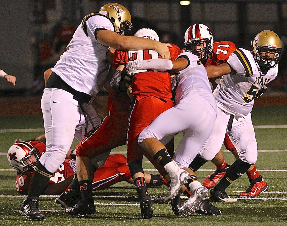 Image: Aaron Pittmon(72) and Joe Celis(8) make a Panther sandwich as Chris Davila(54) backs them up.