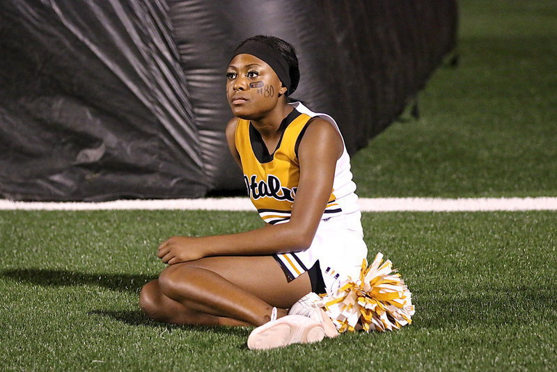 Image: Italy High School cheerleader K’Breona Davis takes a break before the second-half begins.