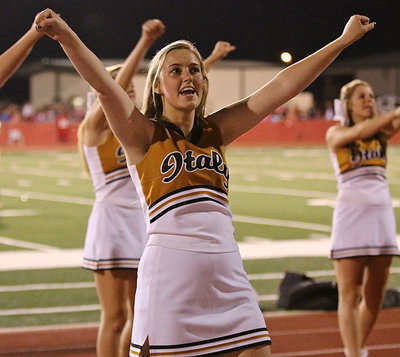 Image: Italy High School cheerleader Kelsey Nelson leads the cheers against Maypearl.