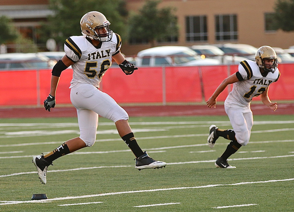 Image: David De La Hoya(56) kicks off for Italy to start the rivalry game against Maypearl.