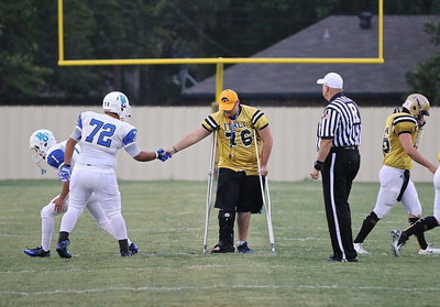 Image: Senior Gladiator Colin Newman(76) and a Blooming Grove player share in good sportsmanship after the coin toss.