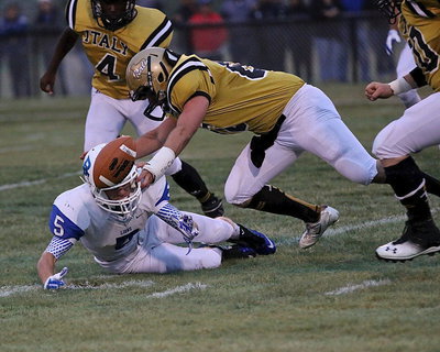 Image: Italy’s Kyle Fortenberry(66) helps force a turnover during an Italy punt. Fumble!!!