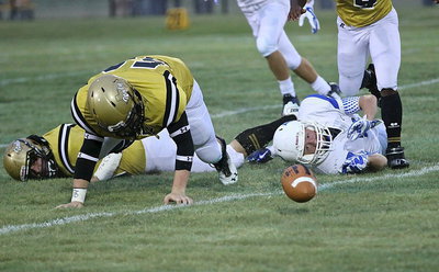 Image: Gladiator John Escamilla(50) tries to claw his way to the loose ball.